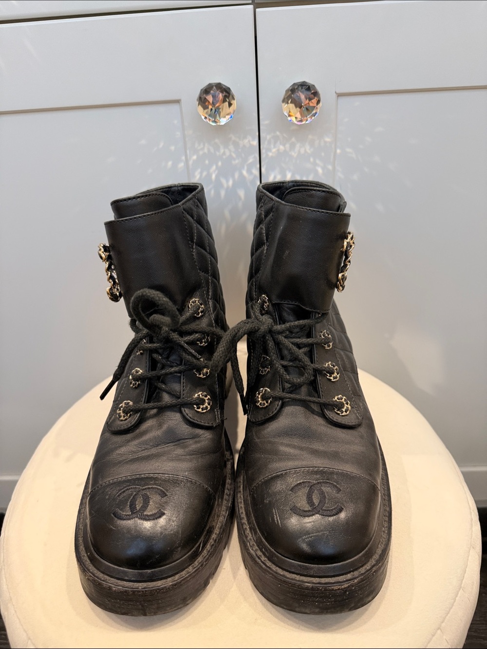 CHANEL Black Quilted Lace-Up Combat Boots with Gold Chain Accents